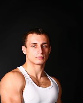 handsome guy in tank top on the black
