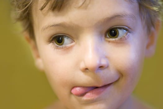 face of the little boy with protruded tongue