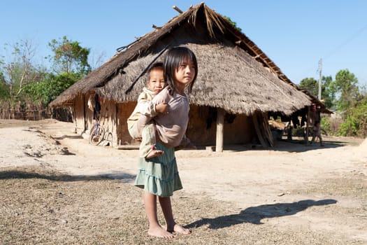 Children in poverty,sister has little brother piggybacking