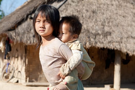 Children in poverty,sister has little brother piggybacking