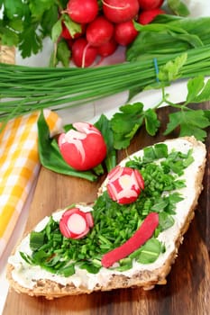 a roll topped with cream cheese,chives and fresh wild garlic