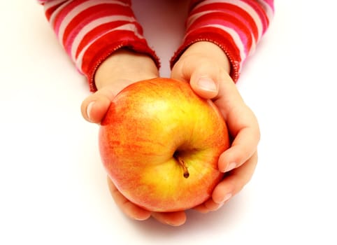 child is holding fresh apple on hands
