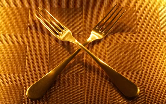 two vintage silver forks on the candle light