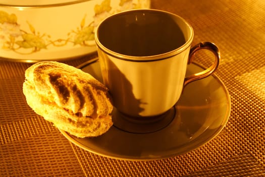a cup of tea with zephyr on a candle light