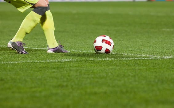 Soccer players running after the ball