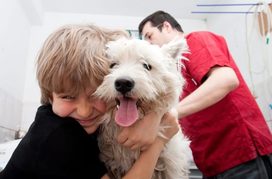 Little boy at vet with his dog