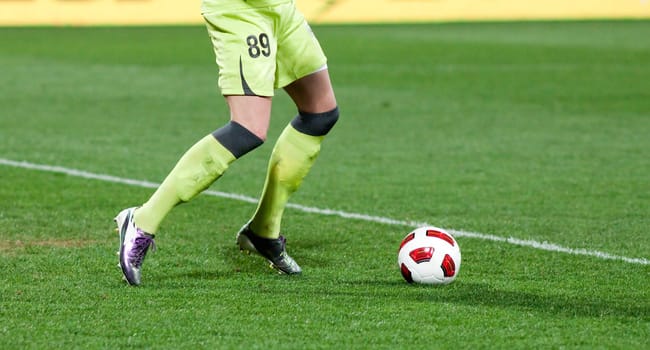 Soccer players running after the ball