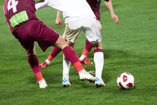 Soccer players running after the ball