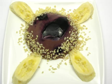 Chocolate pudding with blueberries,bananas and almonds