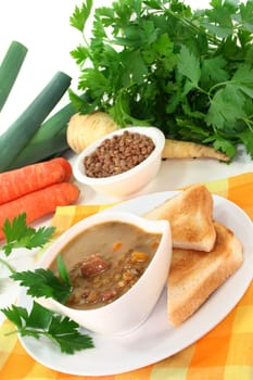 a bowl of lentil soup with bacon and parsley