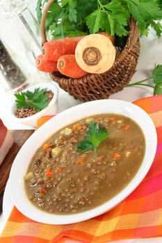 a bowl of lentil soup with bacon and parsley