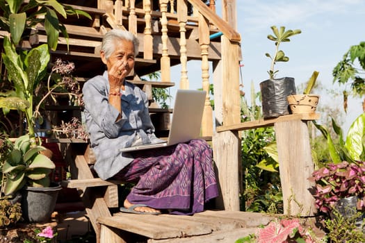 Old woman with laptop,wireless connection in remote places