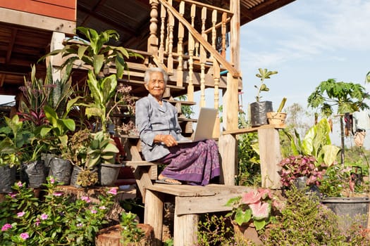 Old woman with laptop,wireless connection in remote places