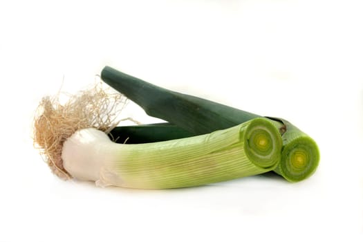 a cut leek stick against a white background
