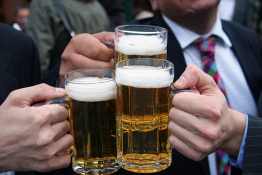 business men toasting with their beers