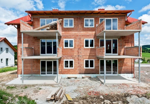 Family House under construction with scaffold on the facade