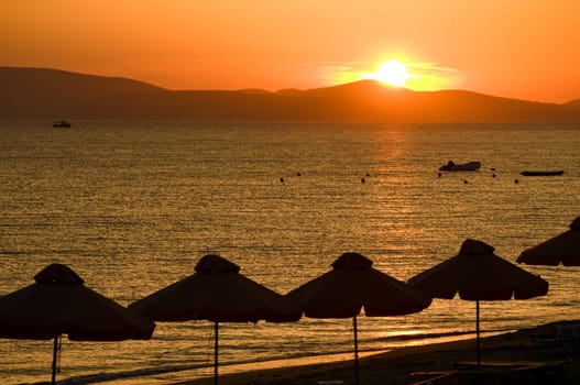 View from the beach with a glowing sun setting in the horizont