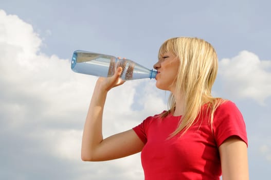 Young woman drinking water from a bottle