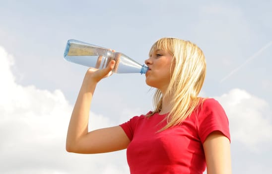 Young woman drinking water from a bottle