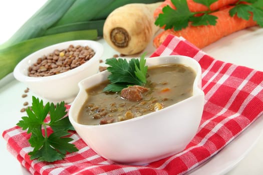 a bowl of lentil soup with bacon and parsley