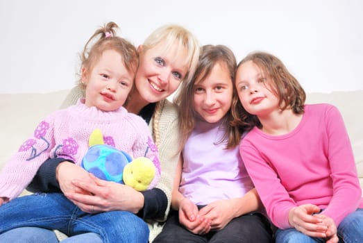 Family sitting in living room on sofa