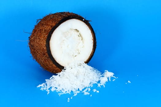 Coconut with coconut meal isolated on blue background