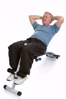 Mature adult exercising his abdomen to stay in shape