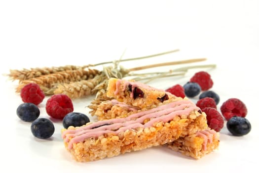 a muesli bar with raspberries and blueberries