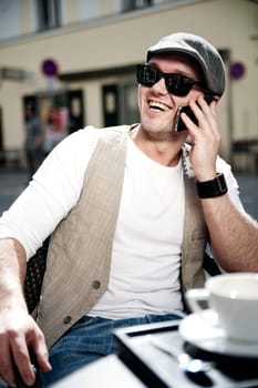 Cheerful man take a call with his smartphone