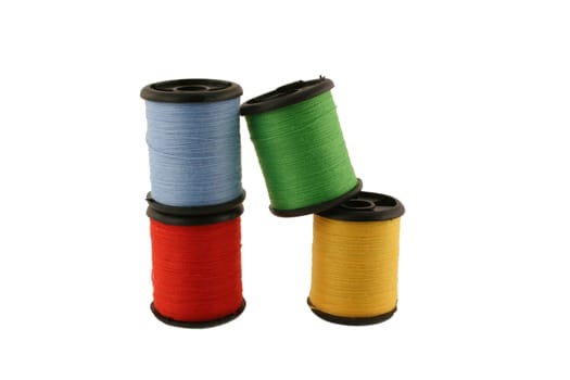 Red spool of thread over white