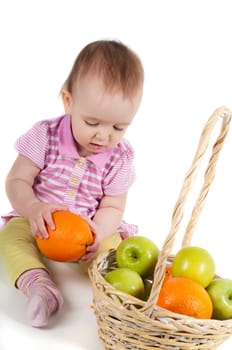 Shot of baby girl in pink with fruits