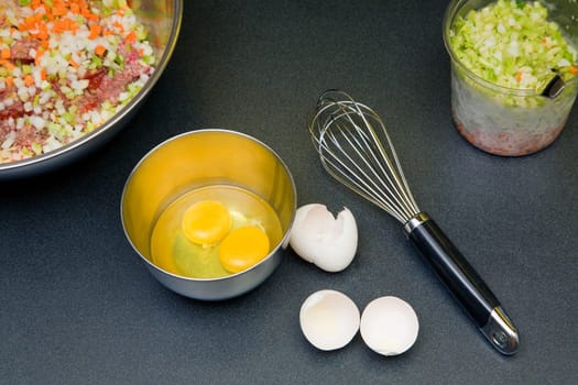 Two eggs in the ball with other ingredients for meatloaf