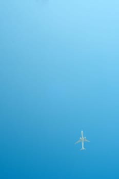 Small airplane on blue sky flying high