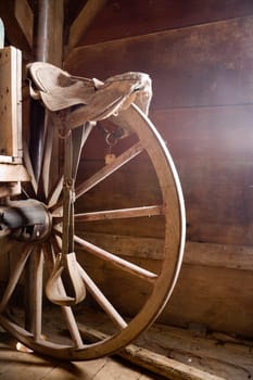 Fragment of a wheel of antique horse-drawn wagon stored in a barn