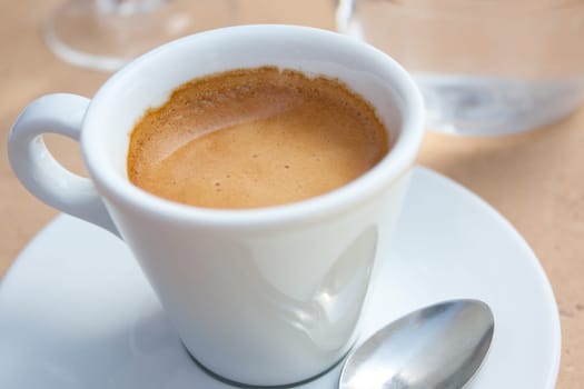 white cup of coffee, espresso and glass of water