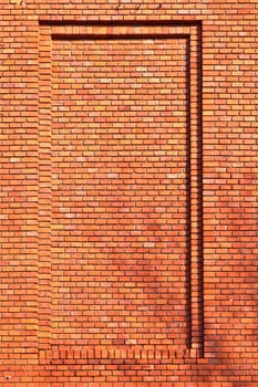 red brick wall of an old house with shadow