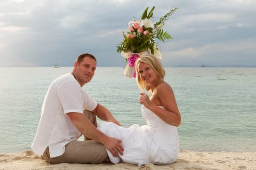 Wedding,couple traveling with wedding dress on the beach