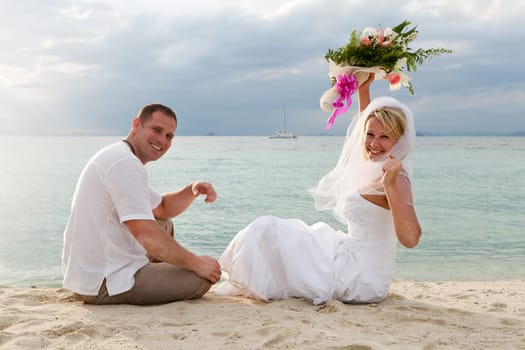 Wedding,couple traveling with wedding dress on the beach
