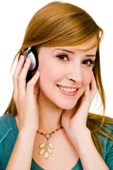 Caucasian woman wearing headphones and listening to music isolated over white
