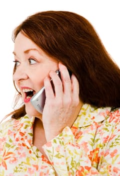 Woman talking on a mobile phone and looking surprised isolated over white