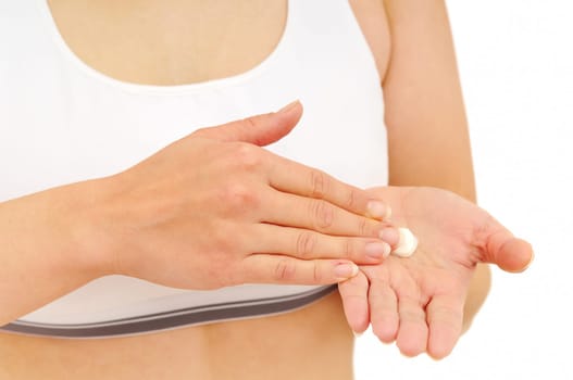 Woman in underwear applies cream on dry hands