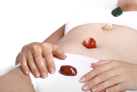 Alternative medicine - healing by semiprecious gems placed on body chakras, shallow depth of field