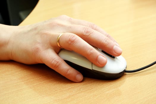 computer mouse with hand on the table