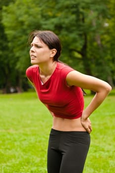 Backpain - sportswoman in pain