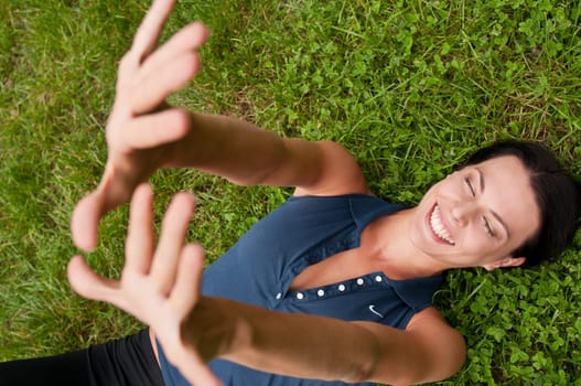 Happiness - woman lying in grass