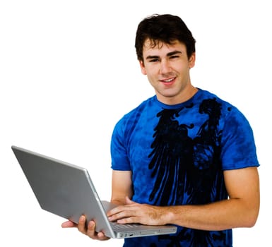 Young man using a laptop and smiling isolated over white