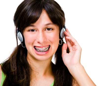 Close-up of a teenage girl wearing headphones and listening to music isolated over white