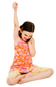 Excited girl talking on a mobile phone isolated over white