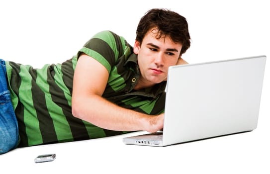 Lying man using a laptop isolated over white