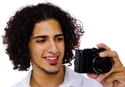 Man photographing with a camera and smiling isolated over white